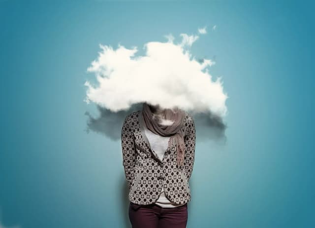 Image of a person with their head in the clouds.